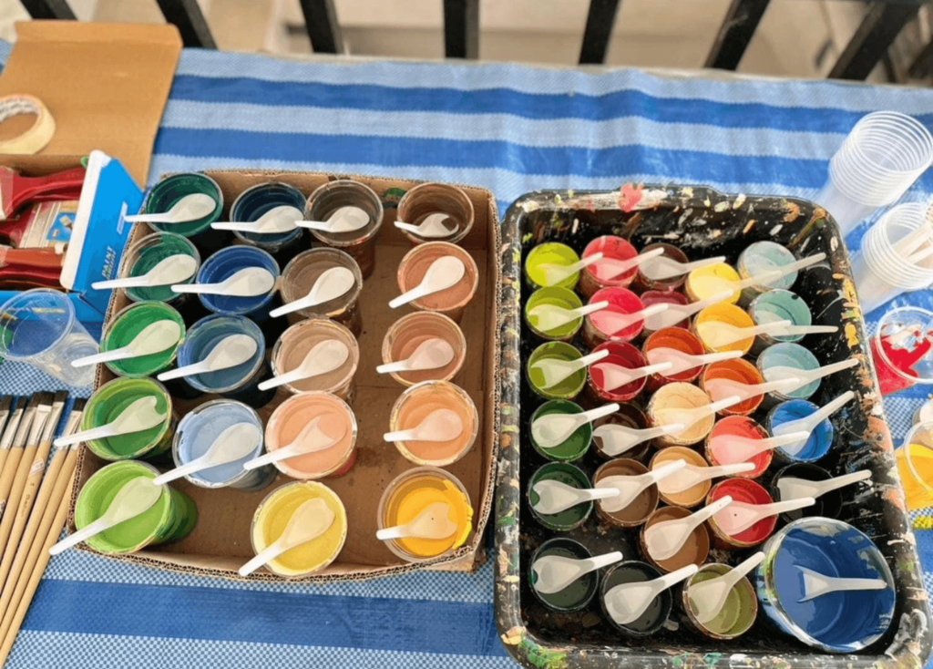 Colorful paint cups arranged on table