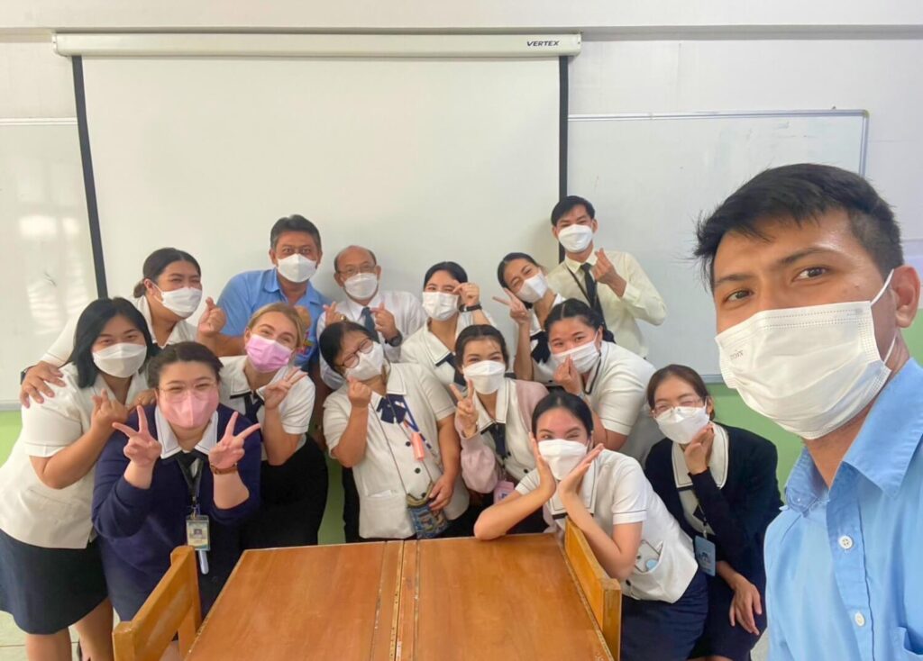 SJC Thai team with BFITS Thailand teachers sharing smiles and heart signs in a cheerful group selfie